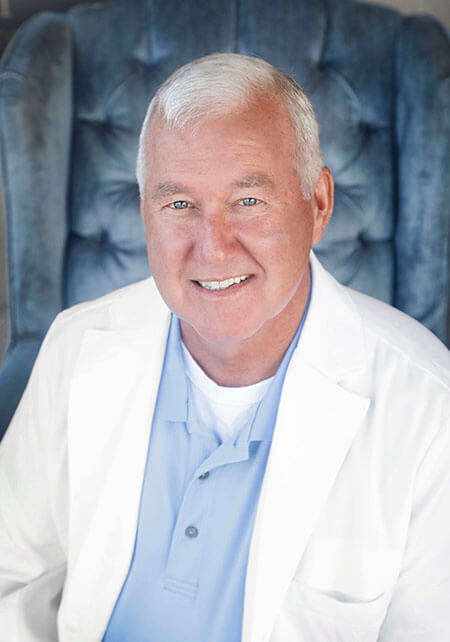 Dr. Glendening smiling while wearing his lab coat