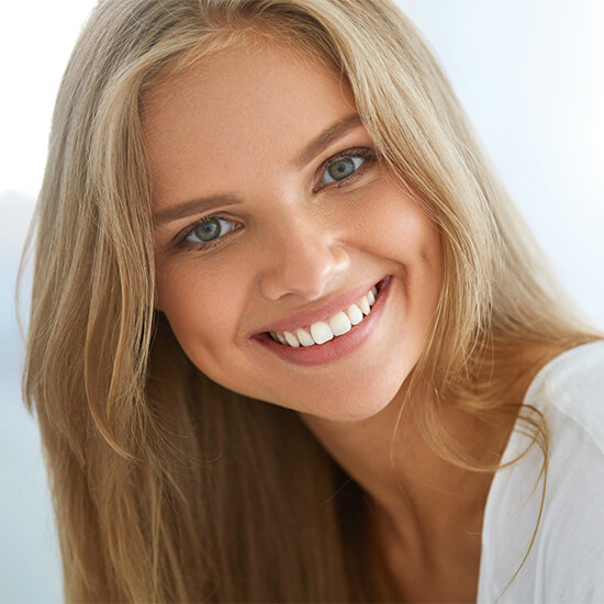 A young woman with long blonde hair smiling 
